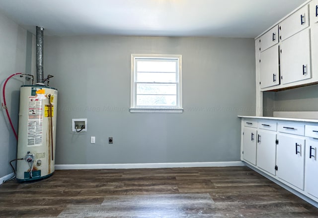 clothes washing area featuring hookup for an electric dryer, baseboards, water heater, cabinet space, and dark wood-style floors