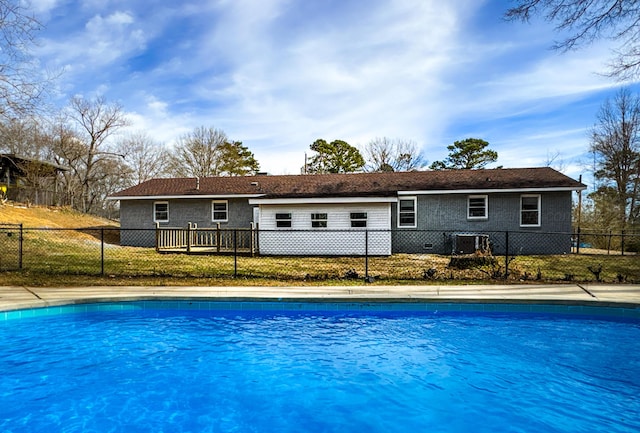 view of pool with a fenced front yard, cooling unit, and a fenced in pool