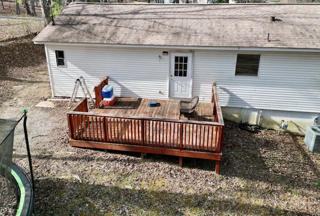 back of property featuring central AC unit, roof with shingles, and a wooden deck