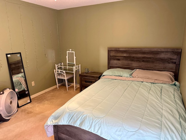 bedroom featuring carpet floors and baseboards