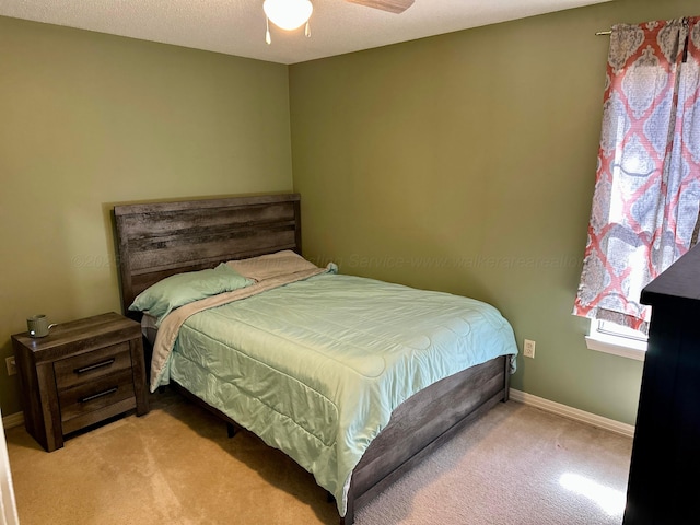 bedroom featuring light carpet and baseboards