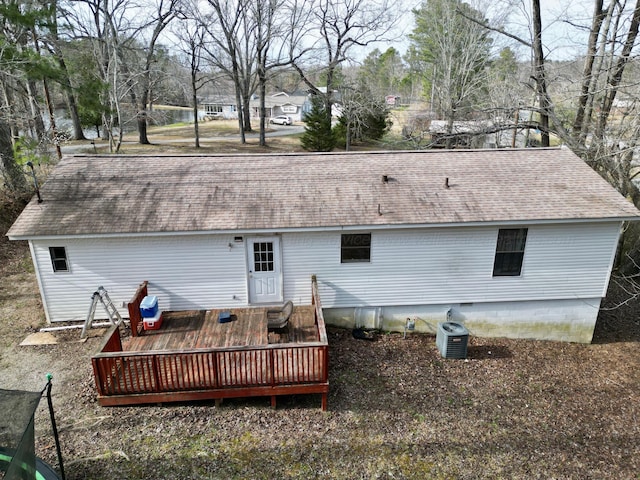 back of house featuring a shingled roof, a deck, and cooling unit