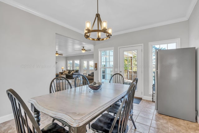 tiled dining space with ceiling fan with notable chandelier and crown molding