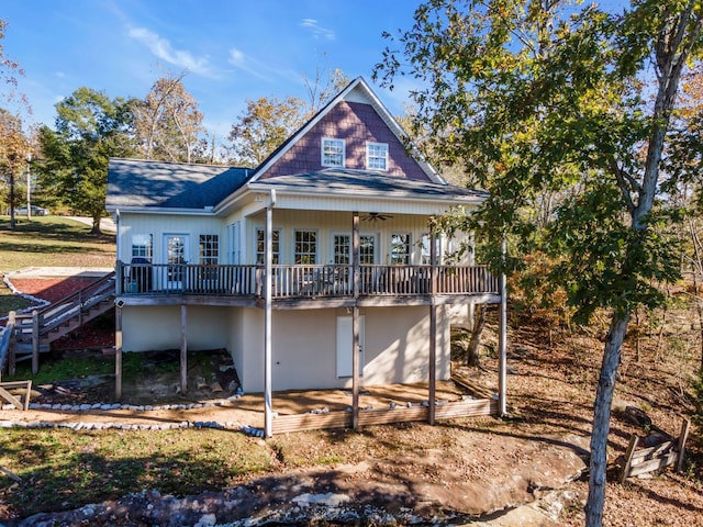 rear view of house featuring a wooden deck and ceiling fan