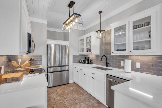 kitchen featuring backsplash, pendant lighting, white cabinets, and stainless steel appliances