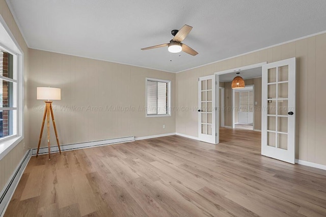 unfurnished room featuring ceiling fan, french doors, a baseboard radiator, and hardwood / wood-style flooring