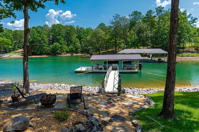 dock area featuring a water view and a fire pit