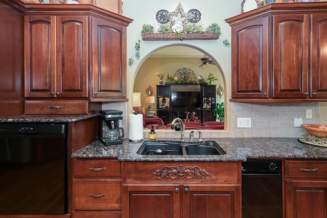 kitchen featuring dark stone countertops, ceiling fan, a sink, dishwasher, and backsplash