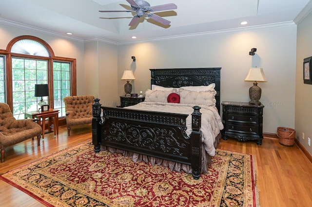 bedroom with recessed lighting, baseboards, wood finished floors, and crown molding