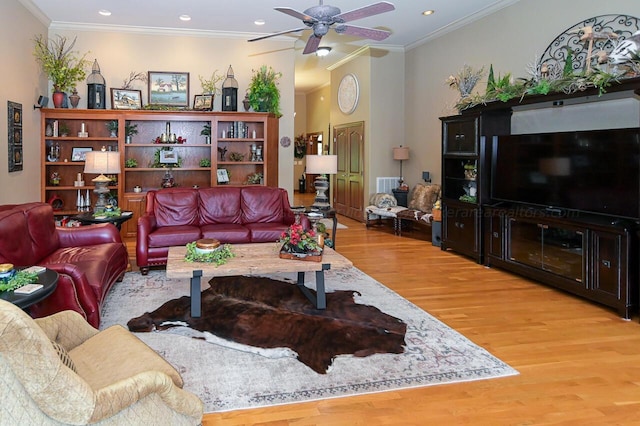 living area with crown molding, light wood-type flooring, and ceiling fan