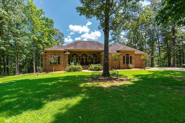 ranch-style house with a front yard, a porch, and brick siding