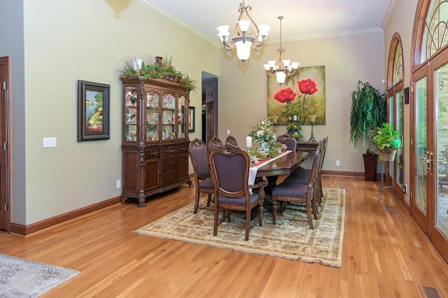 dining space with an inviting chandelier, wood finished floors, and crown molding