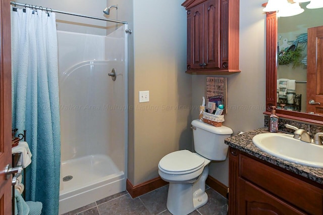 bathroom with toilet, a stall shower, tile patterned flooring, baseboards, and vanity