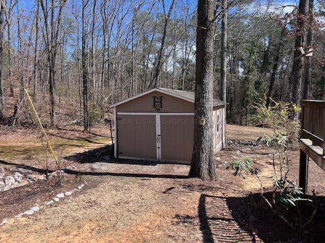 view of shed with a forest view