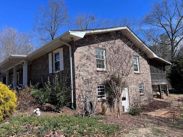 view of side of property featuring brick siding