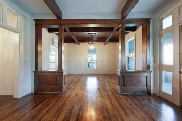 unfurnished dining area featuring a healthy amount of sunlight and dark hardwood / wood-style floors