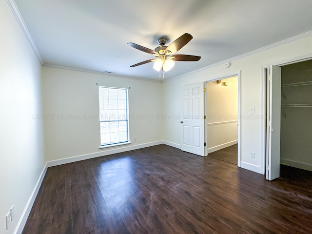 unfurnished bedroom with ceiling fan, ornamental molding, and dark hardwood / wood-style flooring