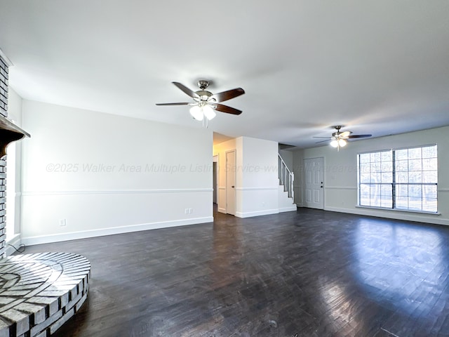 unfurnished living room with dark wood-type flooring and ceiling fan