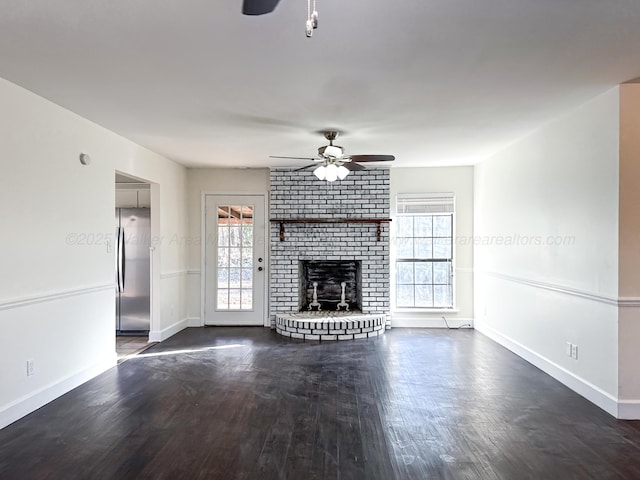 unfurnished living room featuring ceiling fan, dark hardwood / wood-style flooring, and plenty of natural light