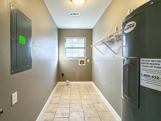 laundry area with electric panel, hookup for a washing machine, and light tile patterned floors