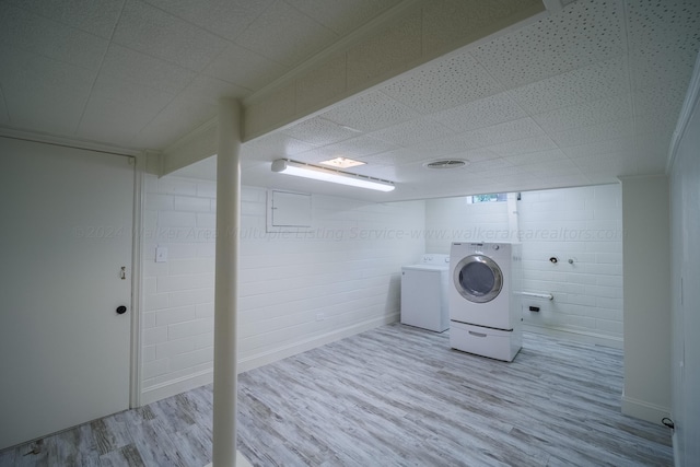 laundry area with light wood-type flooring and washing machine and clothes dryer