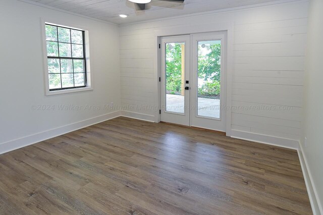 spare room featuring ceiling fan, french doors, dark wood-type flooring, and ornamental molding