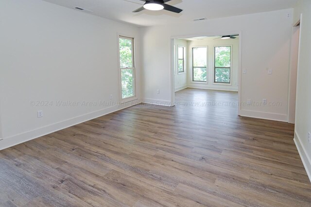 unfurnished room featuring ceiling fan and hardwood / wood-style flooring