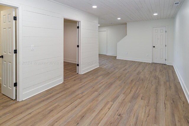 basement with light hardwood / wood-style floors and wooden ceiling