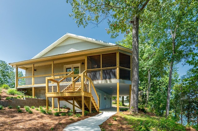 rear view of property featuring a sunroom