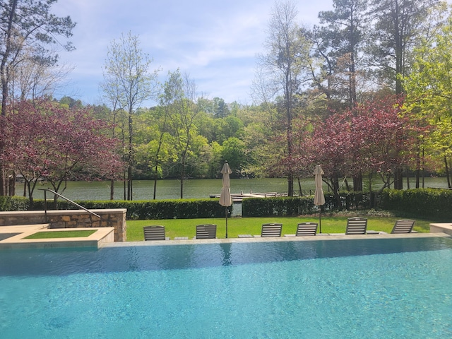 view of pool featuring a lawn