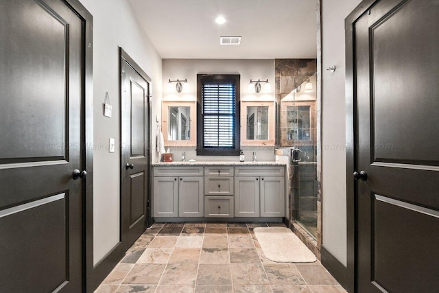 bathroom with an enclosed shower and vanity