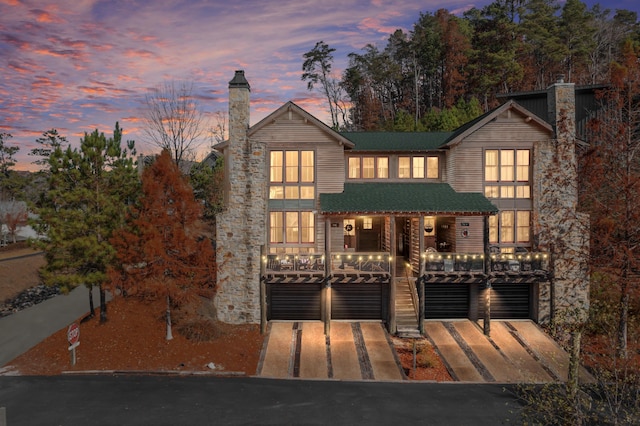 view of front facade featuring covered porch and a garage