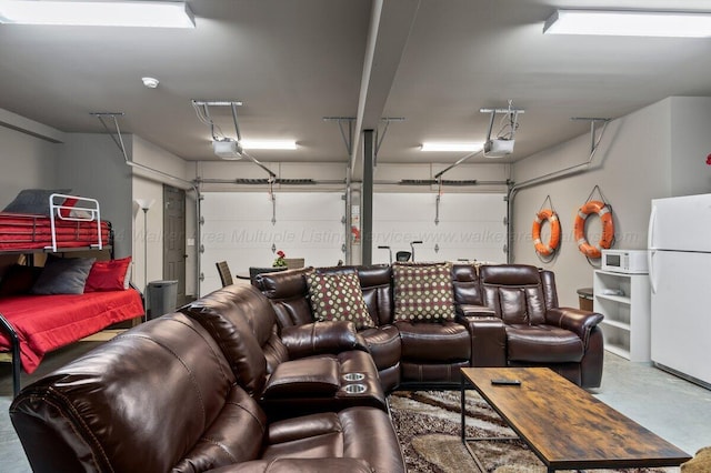 garage with white fridge and a garage door opener