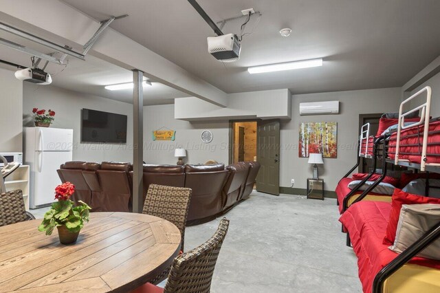 game room featuring a wall unit AC and concrete floors