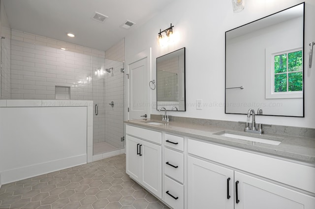 bathroom with tile patterned flooring, vanity, and a shower with shower door