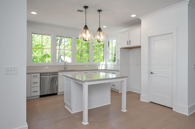 kitchen featuring dishwasher, white cabinetry, plenty of natural light, and a kitchen island