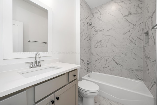 full bathroom with vanity, tiled shower / bath combo, and toilet