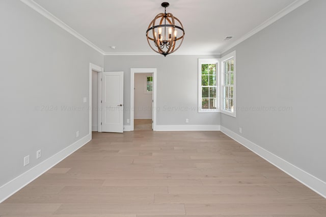 unfurnished room featuring crown molding, a chandelier, and light wood-type flooring