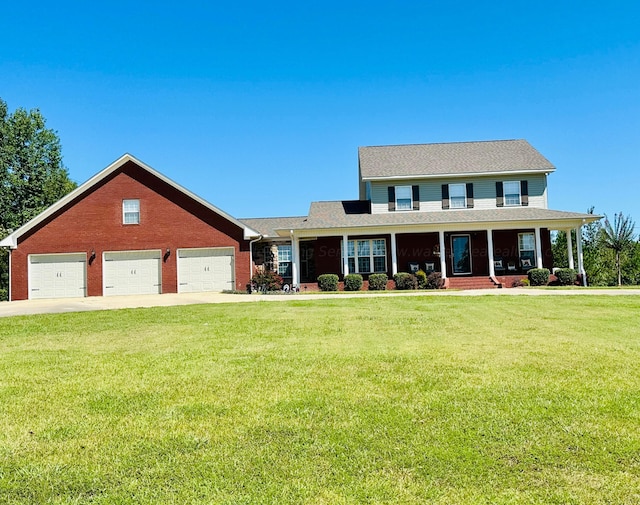 view of front of house featuring a garage, covered porch, and a front lawn