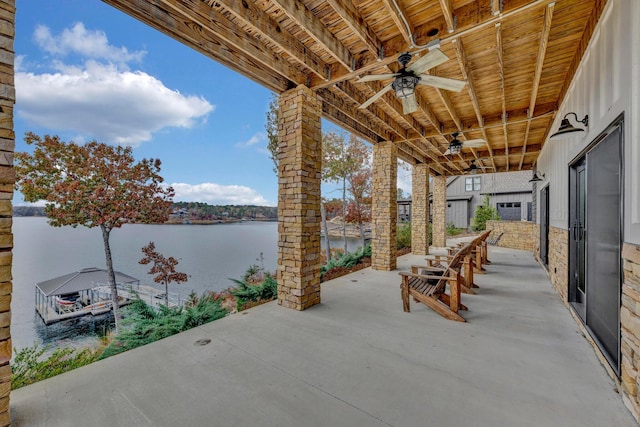 view of patio / terrace with ceiling fan and a water view