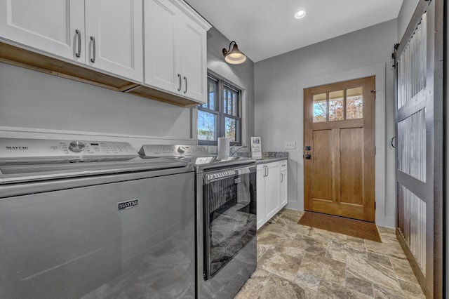 laundry room featuring cabinets and independent washer and dryer