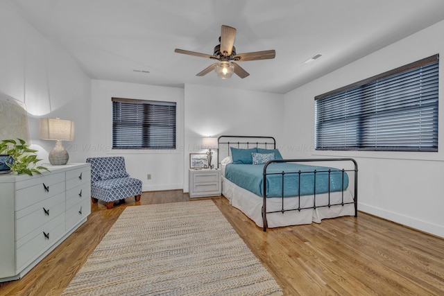 bedroom with ceiling fan and light wood-type flooring