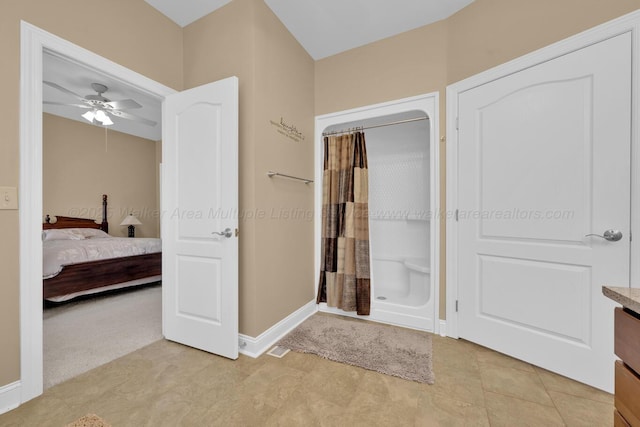 bathroom with walk in shower, vanity, and ceiling fan