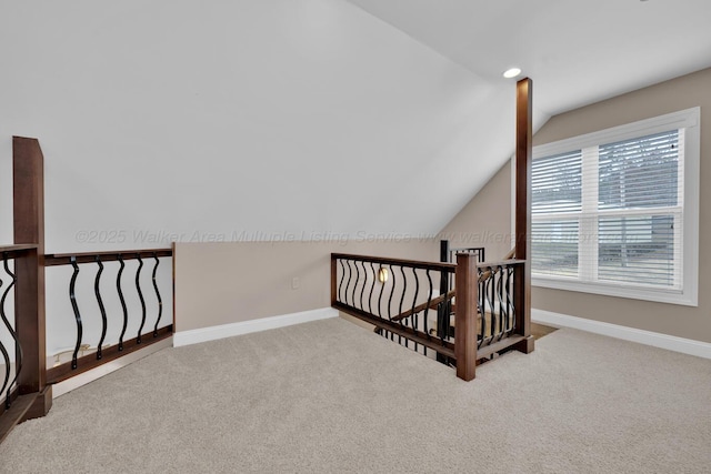 additional living space with carpet floors and vaulted ceiling