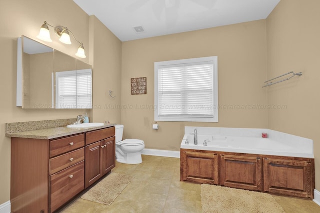 bathroom with a tub, a wealth of natural light, toilet, and vanity