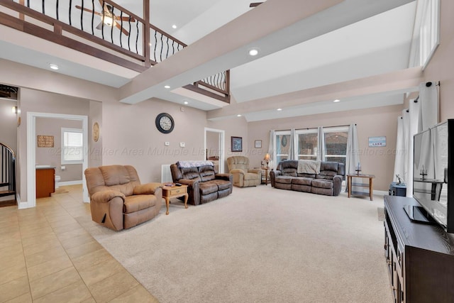 carpeted living room with a towering ceiling