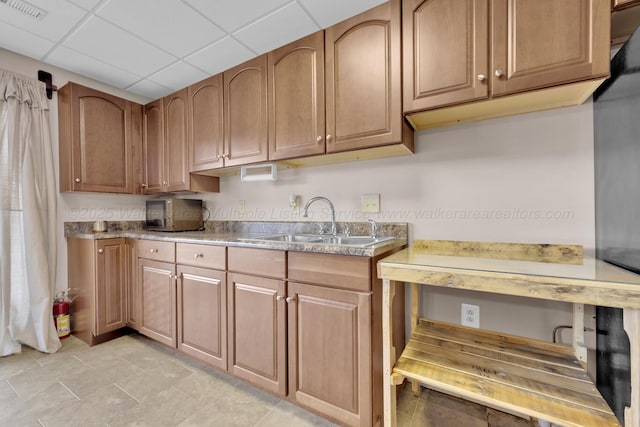 kitchen with a drop ceiling and sink