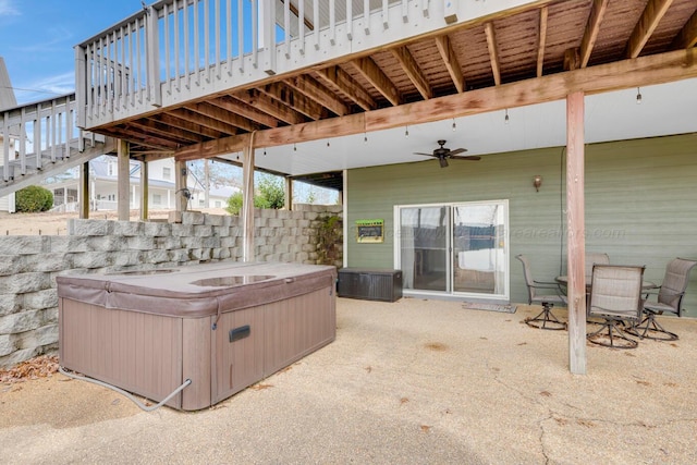 view of patio featuring ceiling fan and a hot tub