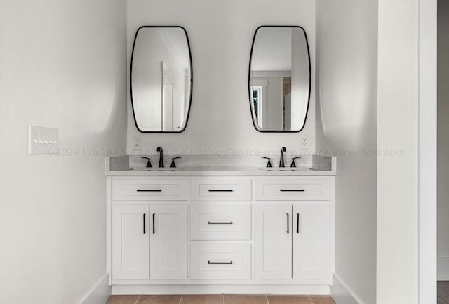 bathroom featuring tile patterned flooring and vanity