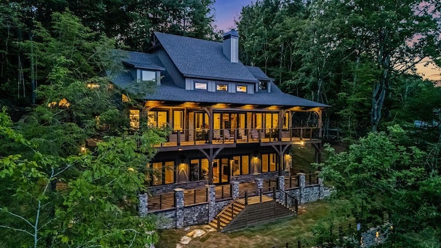 view of back house at dusk